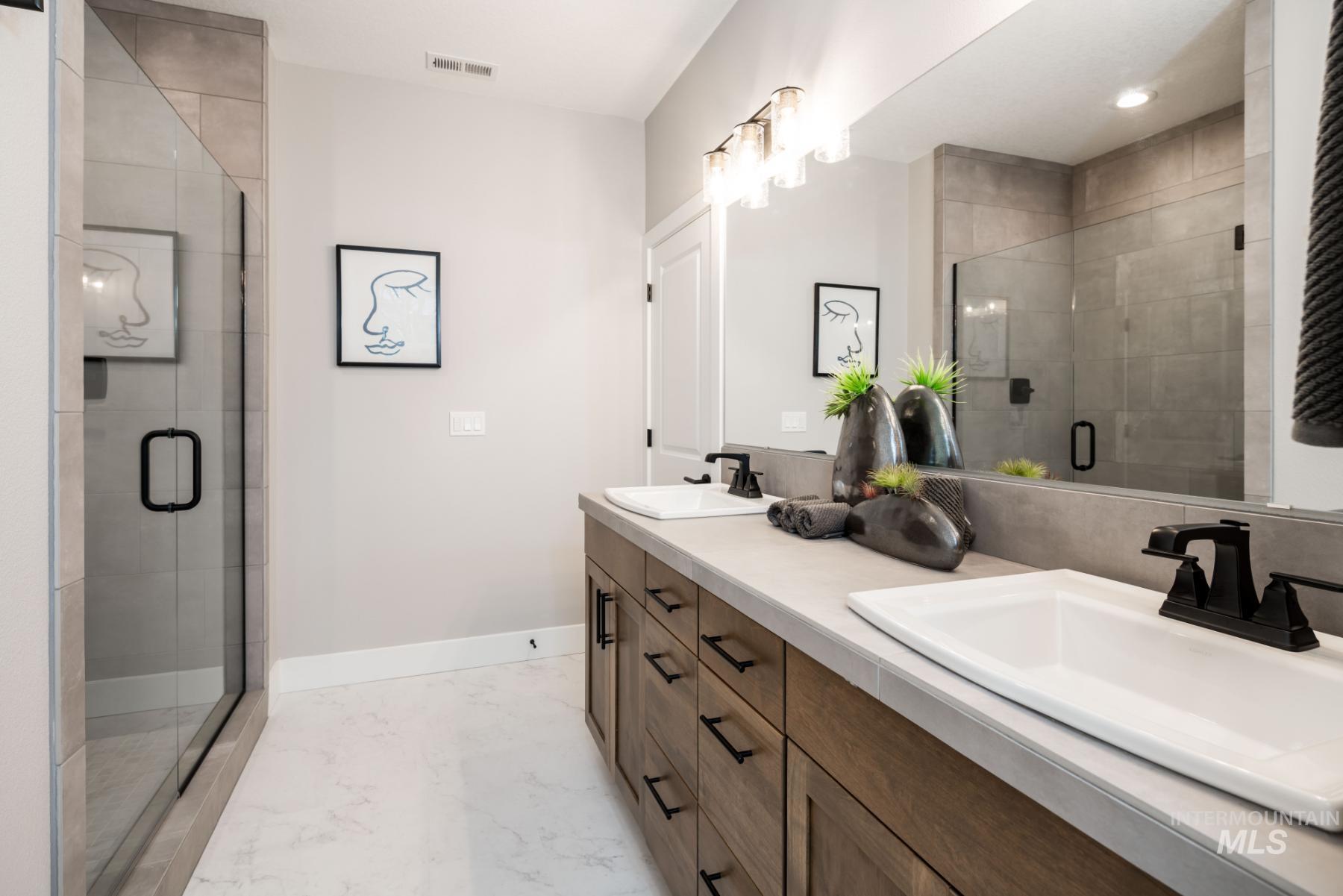 1279 West Malbar Street Meridian, ID 83646 - Photo 20 of 23 Full bath featuring double vanity, a stall shower, and marble finish floors
