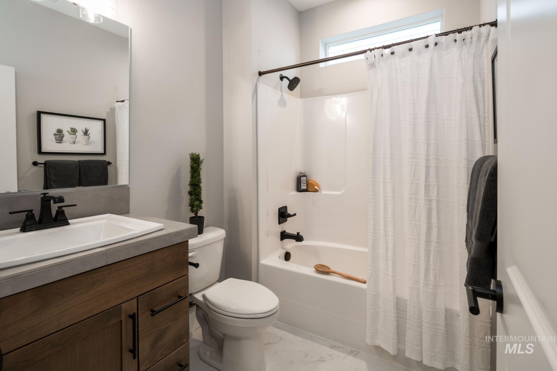 1279 West Malbar Street Meridian, ID 83646 - Photo 21 of 23 Full bath with shower / bath combo with shower curtain and vanity