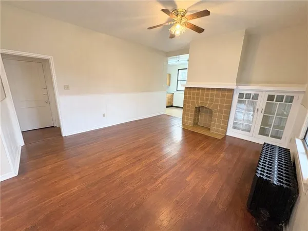 wooden floor in an empty room with a window