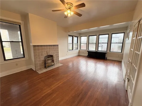 wooden floor in an empty room with a window