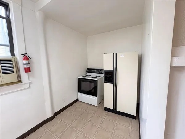 a kitchen with granite countertop white cabinets and window