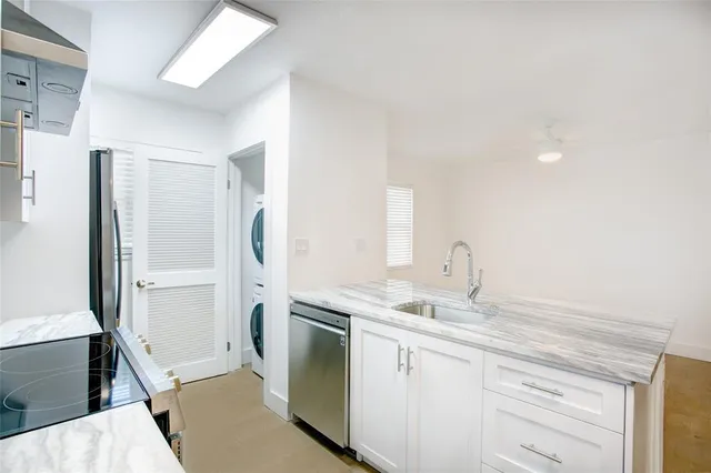 a kitchen with a sink stove and refrigerator
