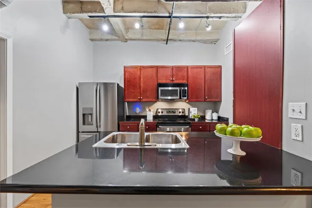 a kitchen with sink and refrigerator