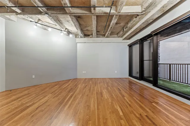 a kitchen with a refrigerator a stove and a sink with wooden floor