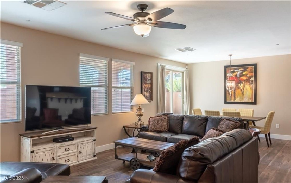 7215 Moonraker Avenue, Unit 111 Las Vegas, NV 89178 - Photo 2 of 5 Living room featuring dark wood finished floors and a ceiling fan