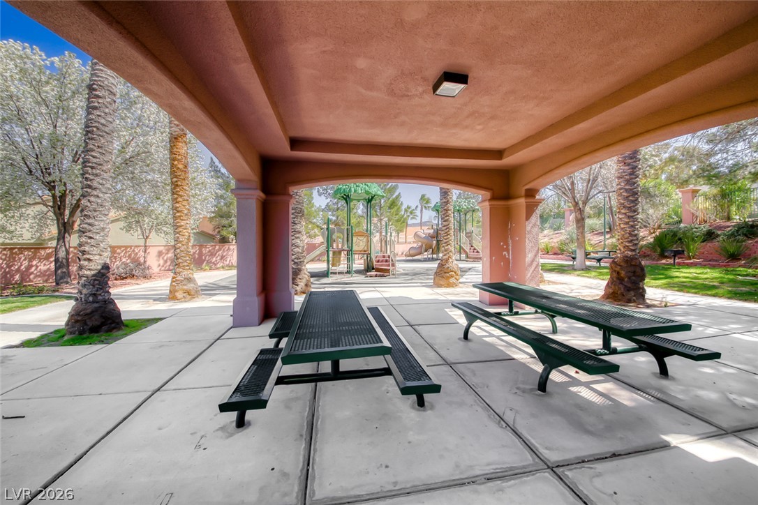 2122 Mooreview Street Henderson, NV 89012 - Photo 44 of 44 A well-maintained community picnic area offers ample seating and convenient access to a vibrant playground.