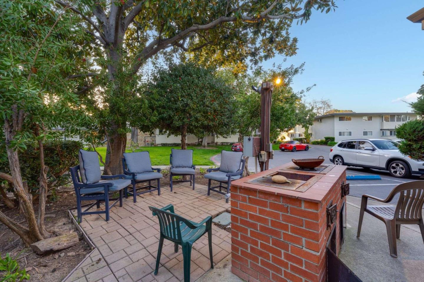 14225 Lora Drive, Unit 59 Los Gatos, CA 95032 - Photo 17 of 20 a backyard of a house with barbeque oven table and chairs