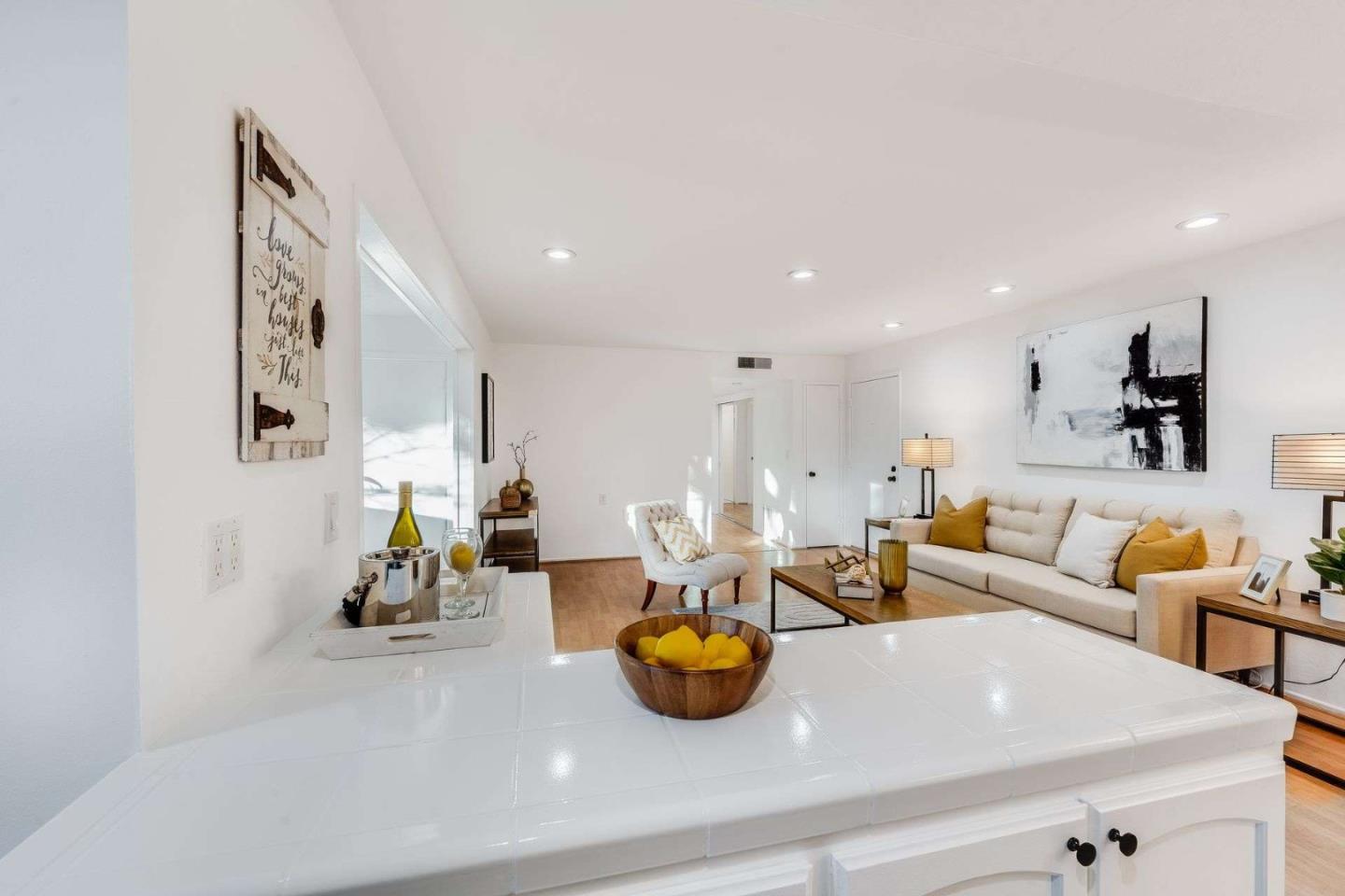 14225 Lora Drive, Unit 59 Los Gatos, CA 95032 - Photo 8 of 20 a living room with furniture and a chandelier