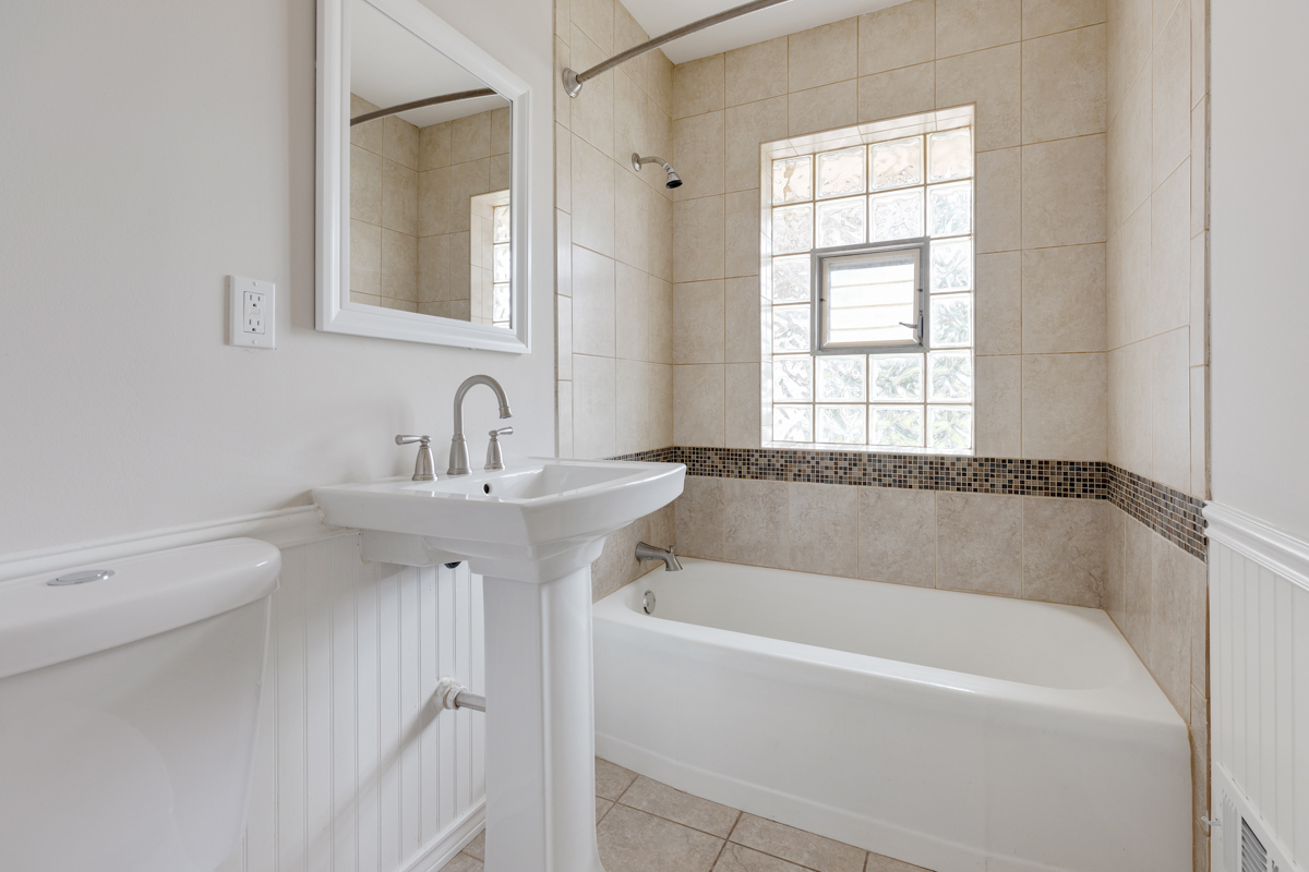 1528 Herbert Avenue Berkeley, IL 60163 - Photo 13 of 25 a white bath tub sitting next to a white sink