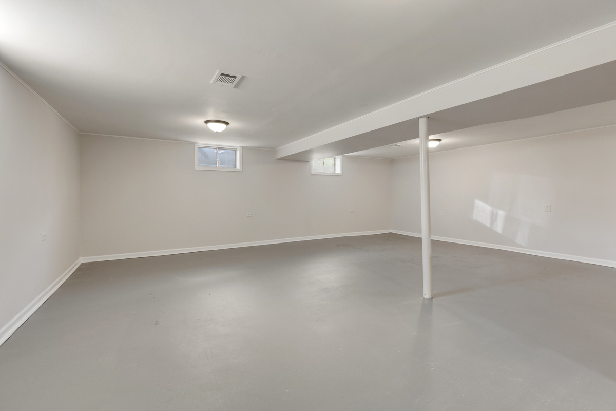 1528 Herbert Avenue Berkeley, IL 60163 - Photo 19 of 25 an empty room with chandelier fan and windows