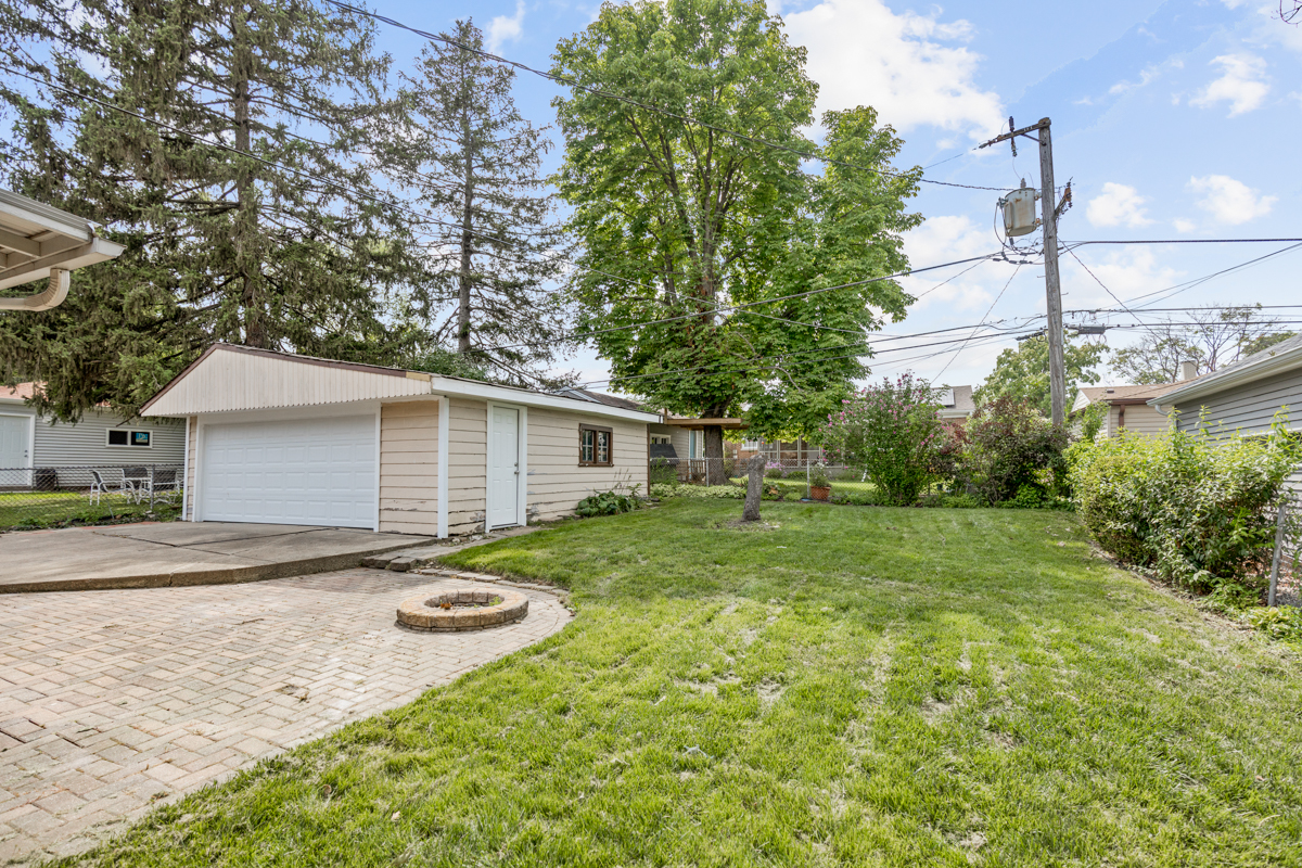 1528 Herbert Avenue Berkeley, IL 60163 - Photo 24 of 25 a view of a backyard with large trees