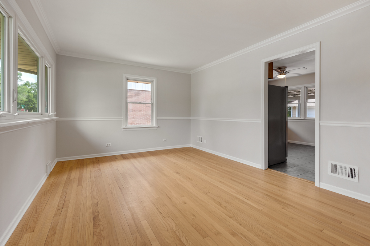 1528 Herbert Avenue Berkeley, IL 60163 - Photo 4 of 25 an empty room with wooden floor and windows