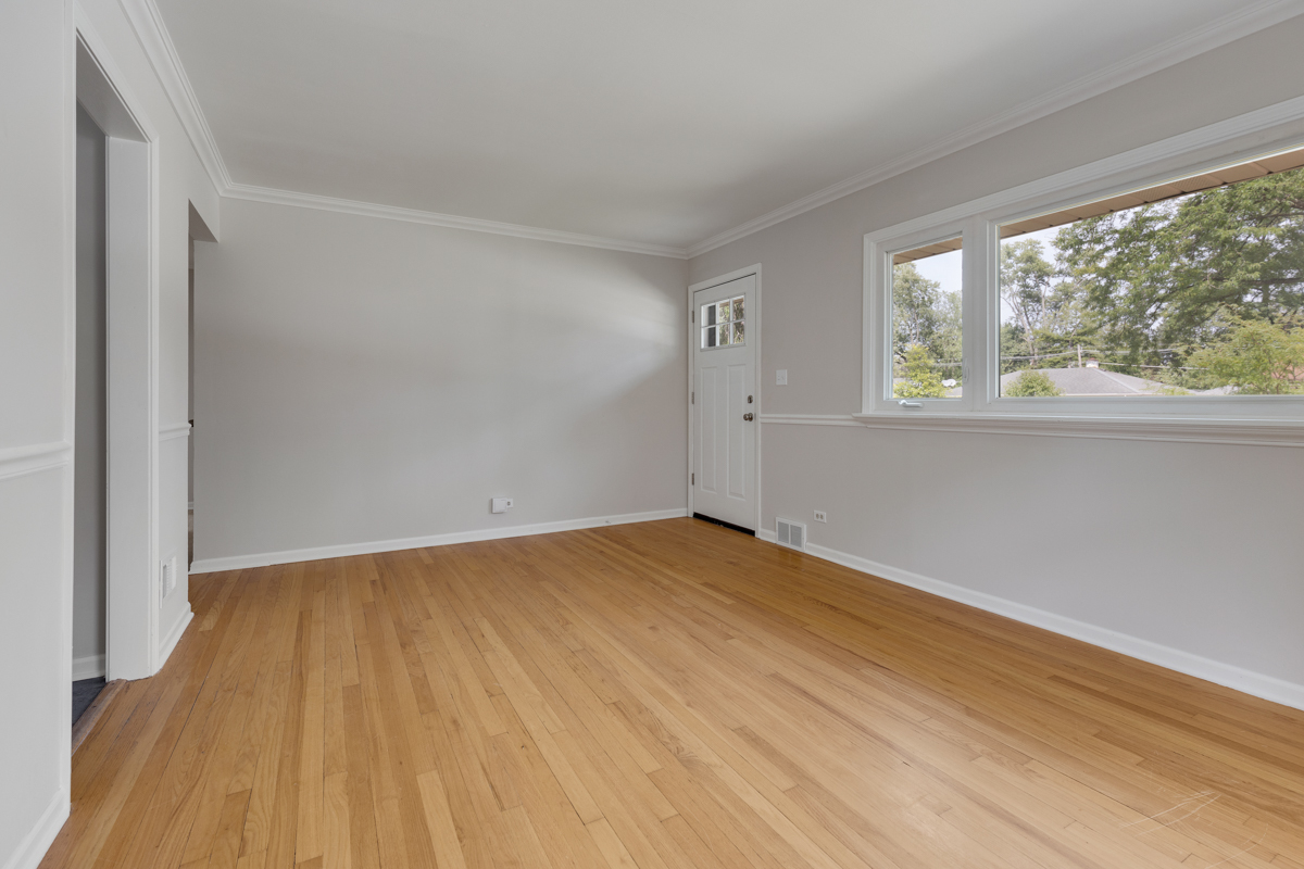 1528 Herbert Avenue Berkeley, IL 60163 - Photo 5 of 25 a view of an empty room with wooden floor and a window