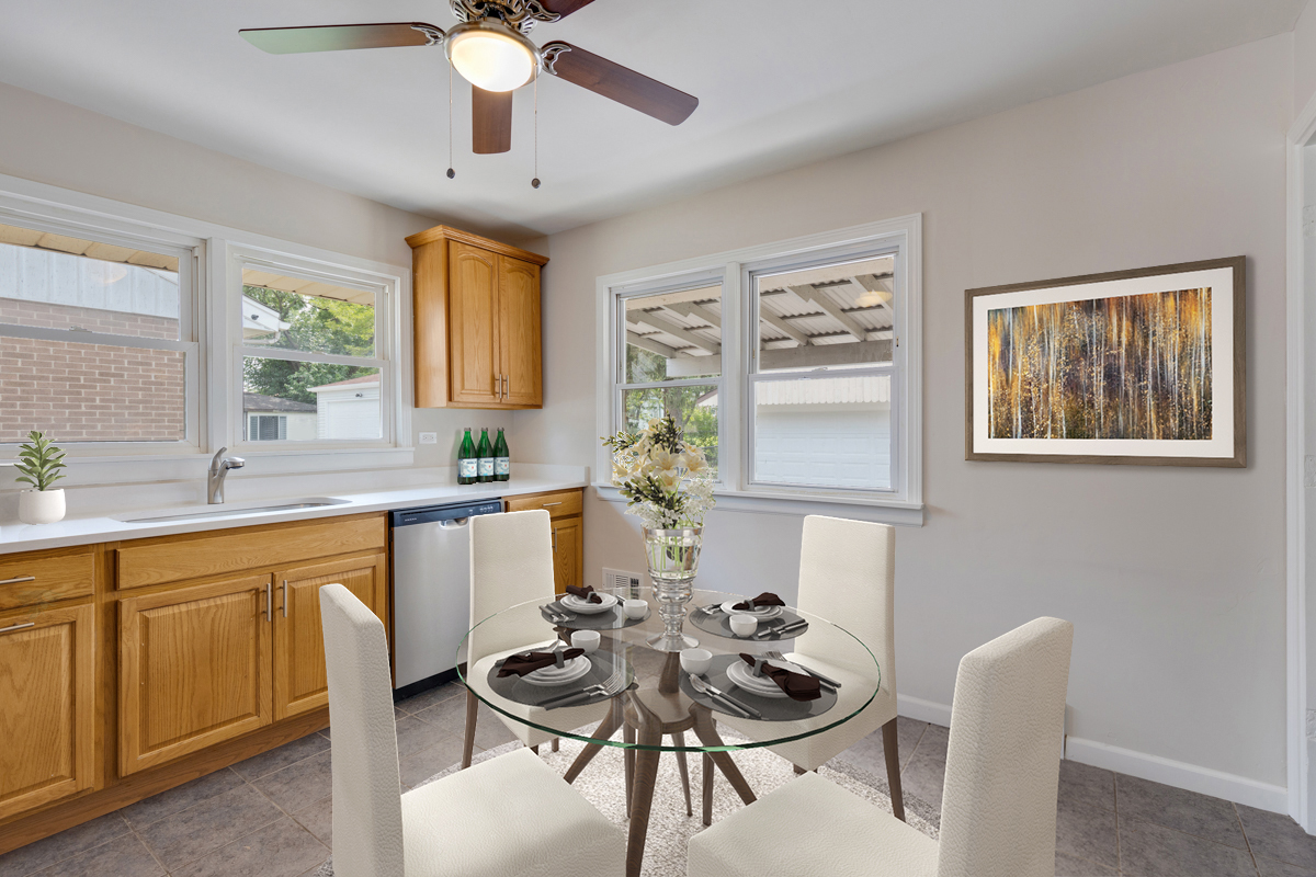 1528 Herbert Avenue Berkeley, IL 60163 - Photo 6 of 25 a kitchen with a dining table chairs and white cabinets