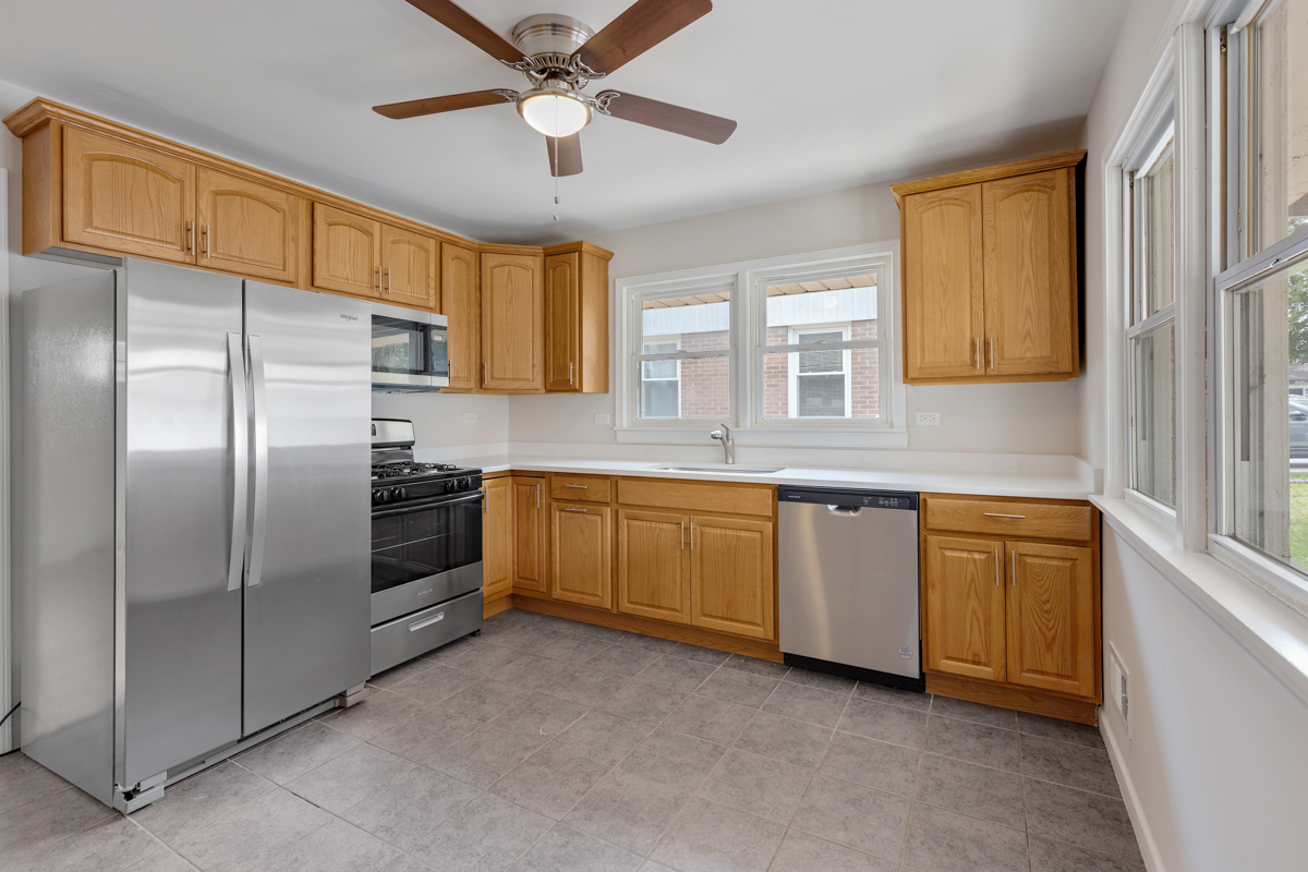 1528 Herbert Avenue Berkeley, IL 60163 - Photo 8 of 25 a kitchen with stainless steel appliances granite countertop a refrigerator a sink and dishwasher