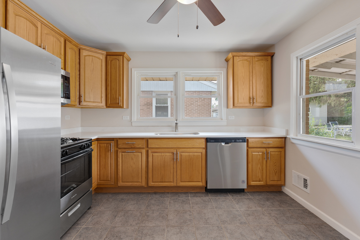 1528 Herbert Avenue Berkeley, IL 60163 - Photo 9 of 25 a kitchen with stainless steel appliances granite countertop a stove a sink and a refrigerator