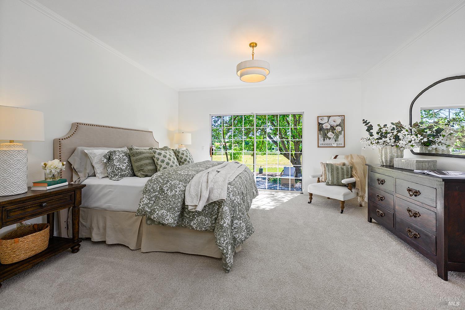 5533 Oak Meadow Drive Santa Rosa, CA 95401 - Photo 24 of 61 Primary bedroom on the main level with peaceful private patio.