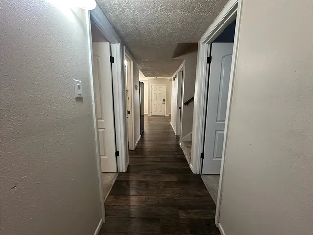 a view of a hallway with a wooden door