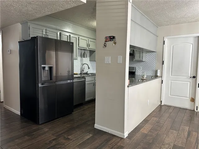 a kitchen with stainless steel appliances a refrigerator and a cabinets