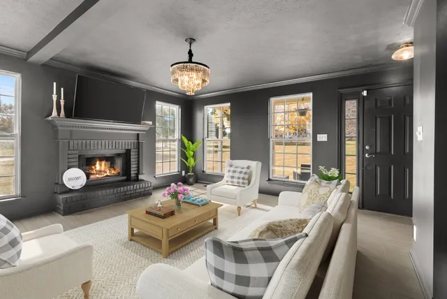 a view of a dining room with furniture a livingroom and chandelier