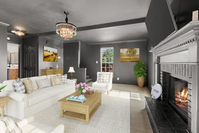 a view of a dining room with furniture a chandelier and wooden floor