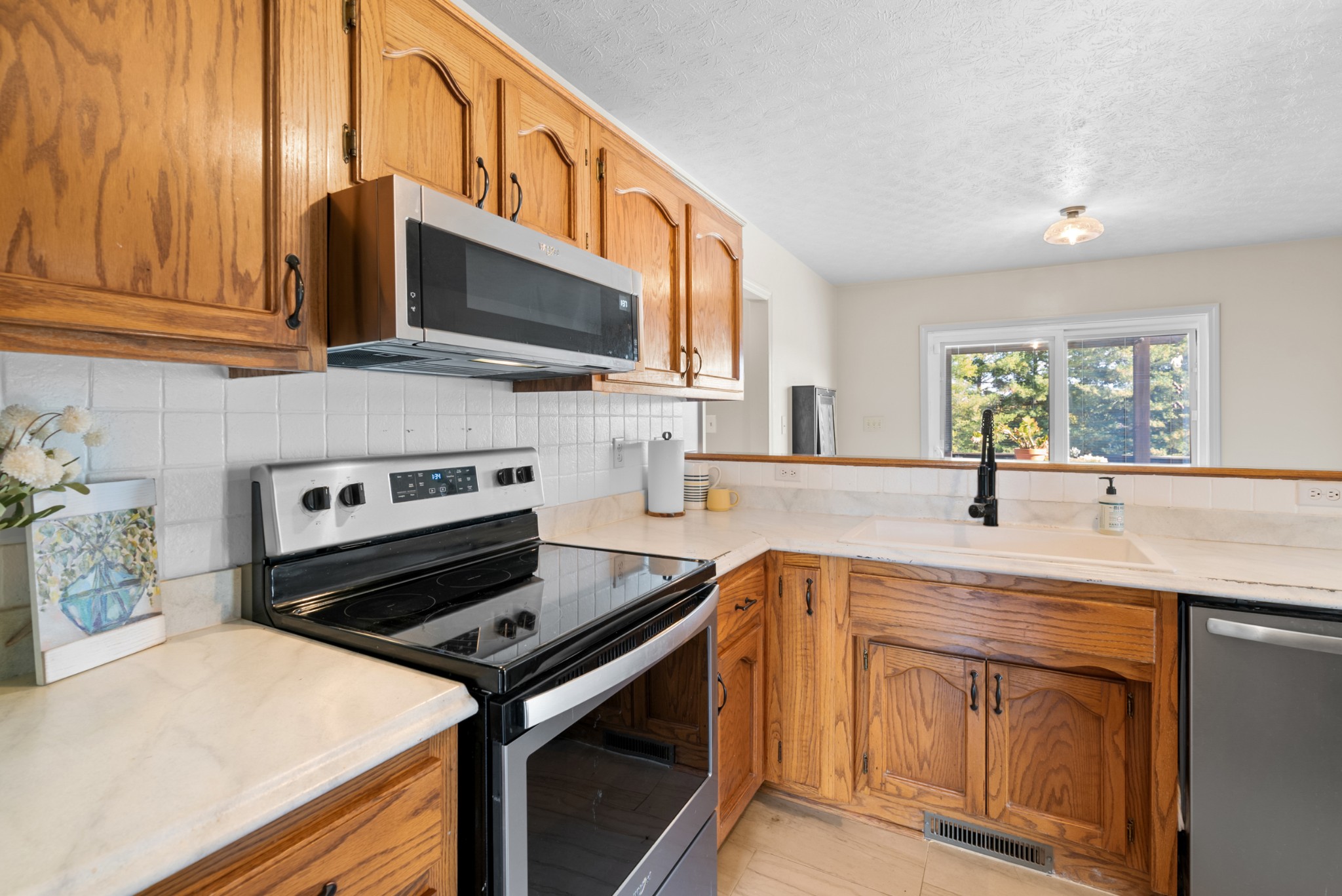 2867 Jack Teasley Road Pleasant View, TN 37146 - Photo 17 of 61 a kitchen with stainless steel appliances granite countertop a stove microwave and sink