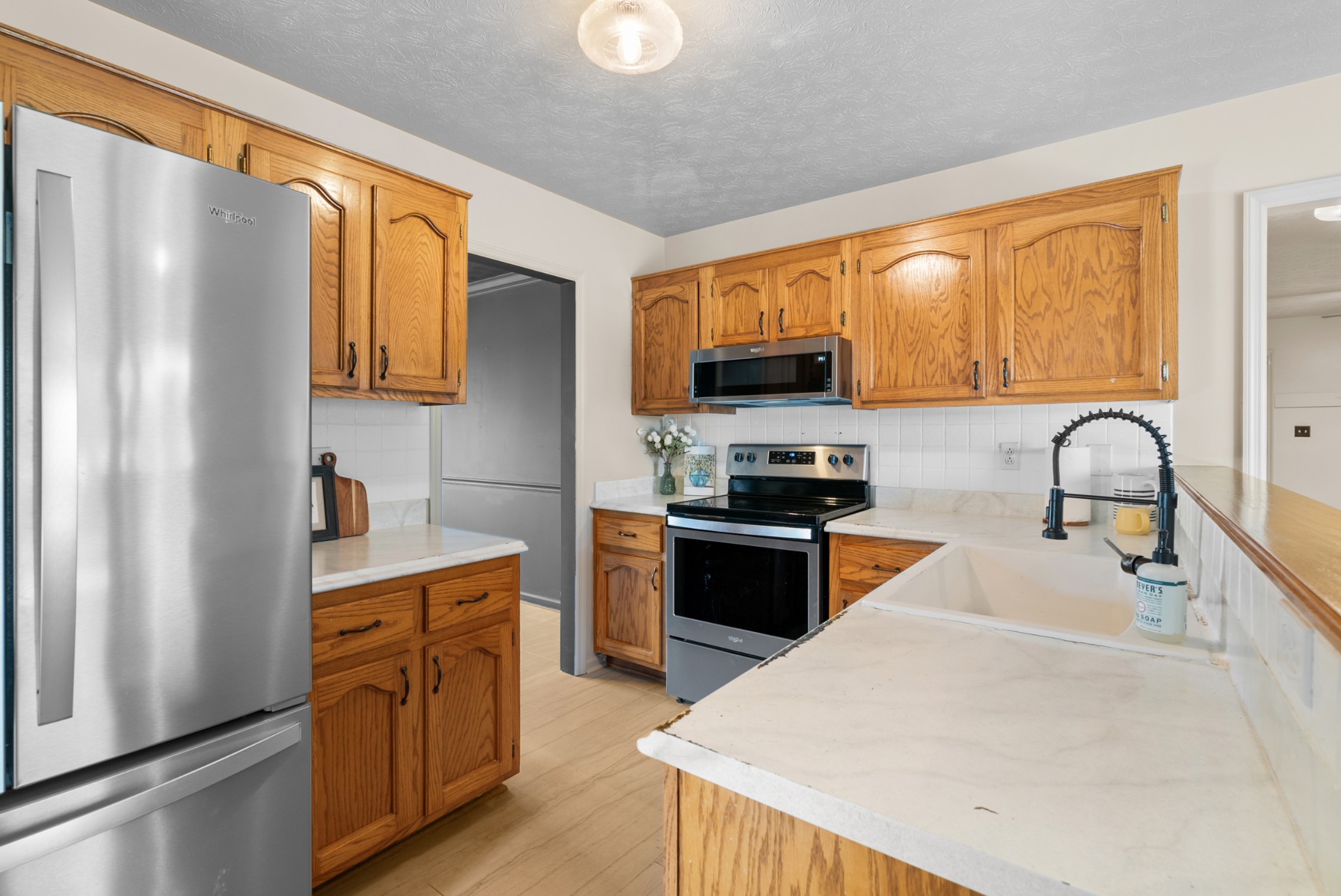 2867 Jack Teasley Road Pleasant View, TN 37146 - Photo 19 of 61 a kitchen with stainless steel appliances granite countertop a refrigerator sink and stove
