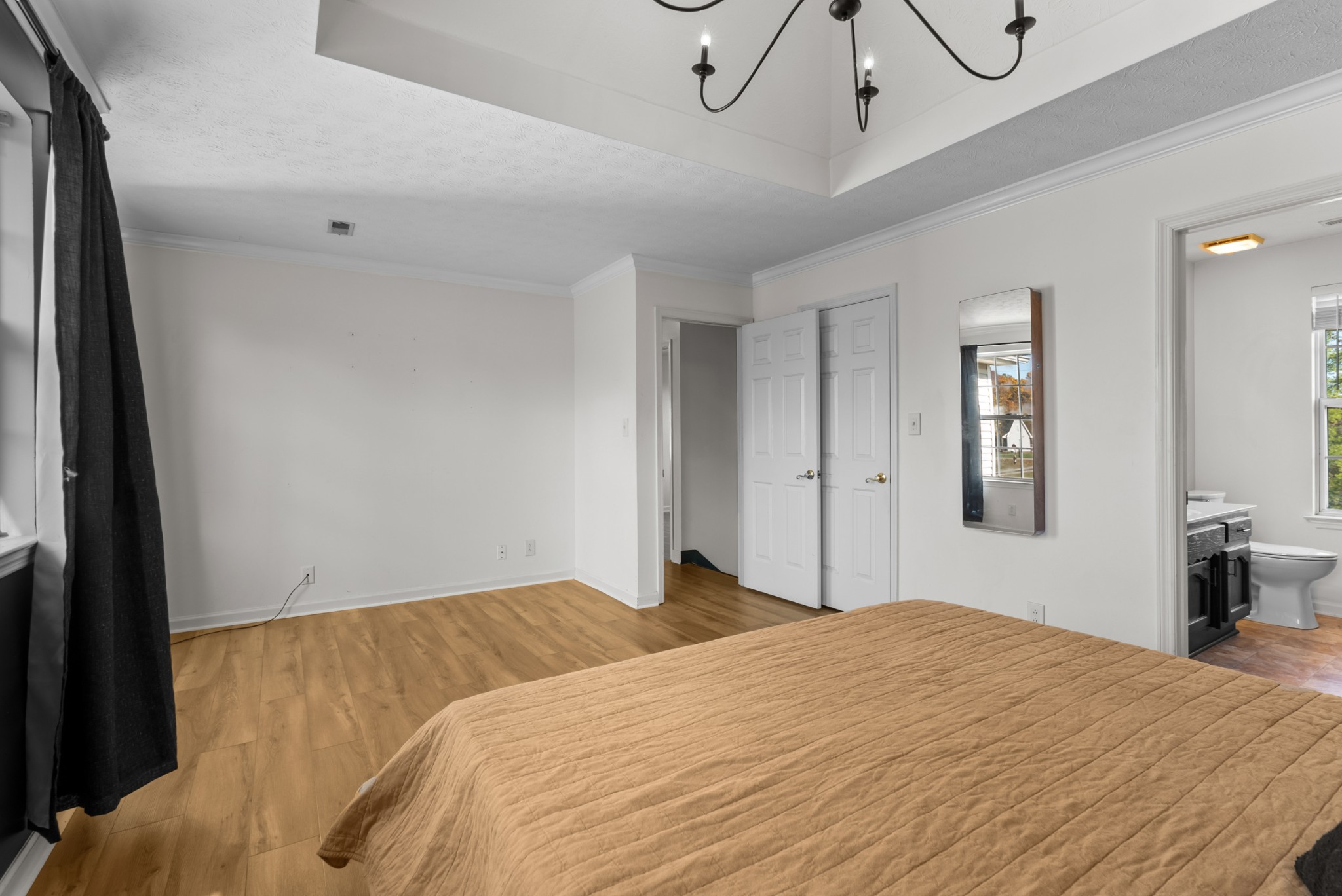 2867 Jack Teasley Road Pleasant View, TN 37146 - Photo 30 of 61 a bedroom with a large bed and chandelier fan