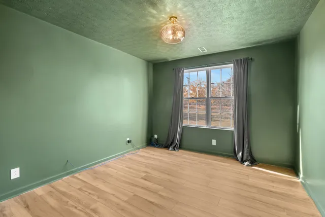 a view of a room with wooden floor and windows