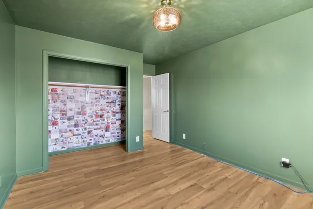 a view of an empty room with a kitchen