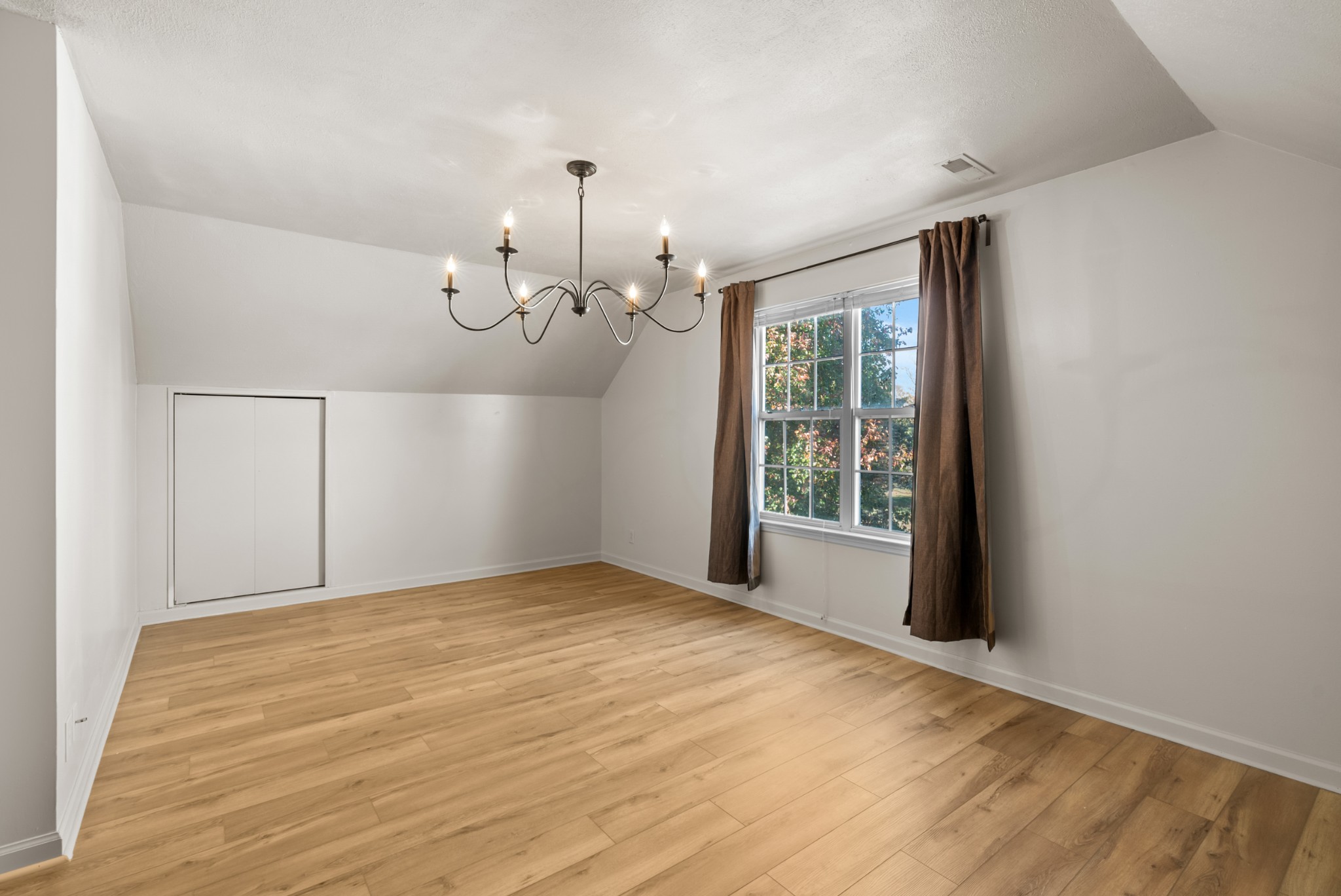2867 Jack Teasley Road Pleasant View, TN 37146 - Photo 42 of 61 a view of an empty room with wooden floor and a window