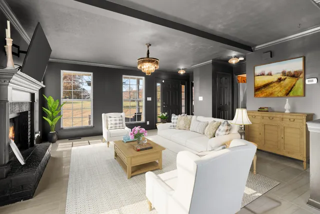 a living room with furniture a fireplace and a flat screen tv