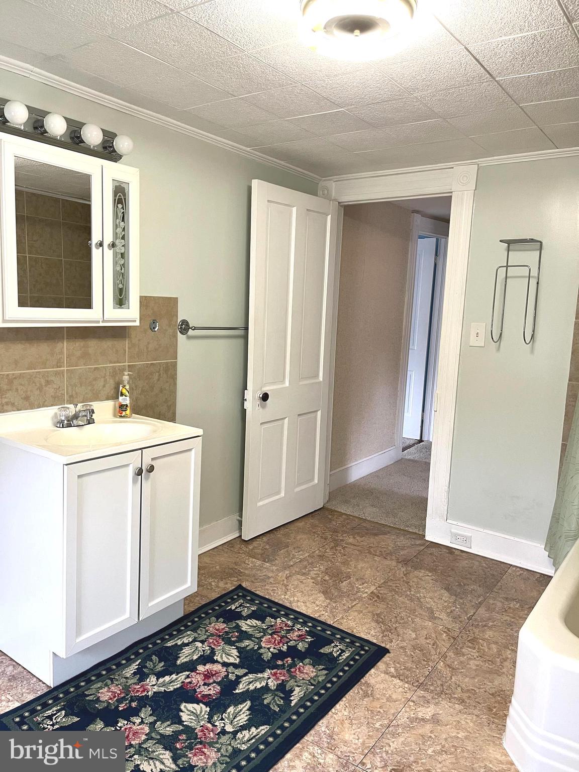 4930 Ridge Road Rosedale, MD 21237 - Photo 24 of 49 a bathroom with a sink and a mirror