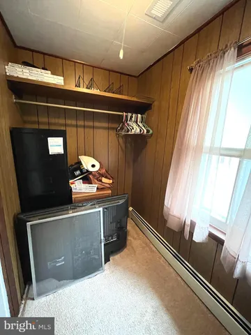 a room with stainless steel appliances wooden floor and window