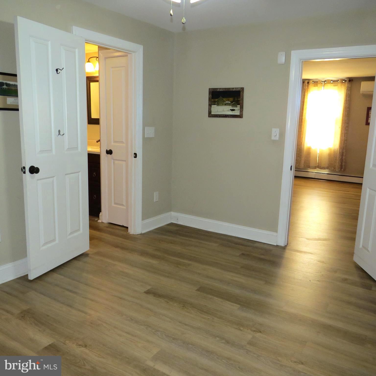 4930 Ridge Road Rosedale, MD 21237 - Photo 4 of 49 an empty room with wooden floor and windows