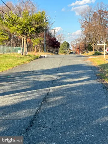 a picture of a bench in front of a white house