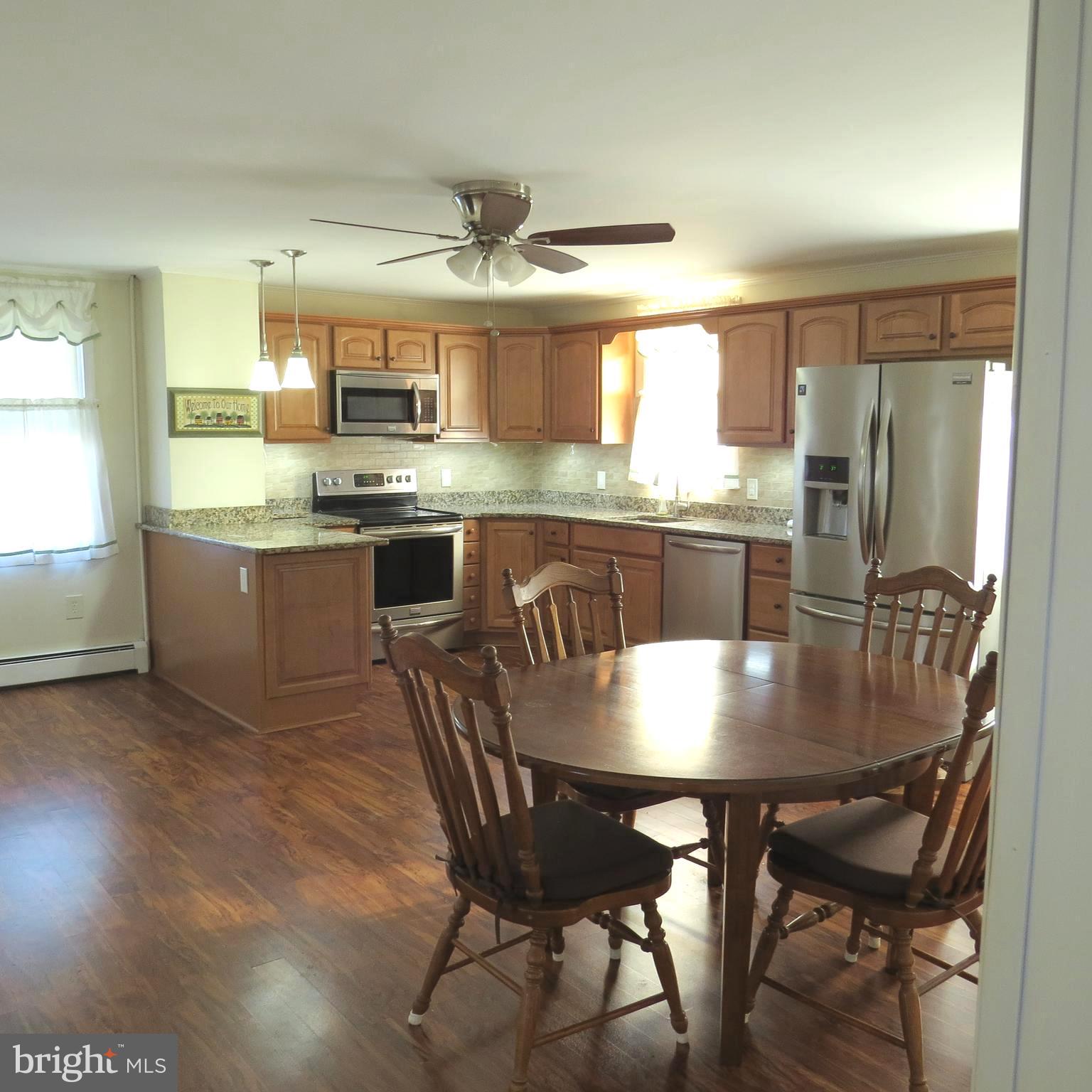 4930 Ridge Road Rosedale, MD 21237 - Photo 6 of 49 a kitchen with kitchen island granite countertop a sink and refrigerator
