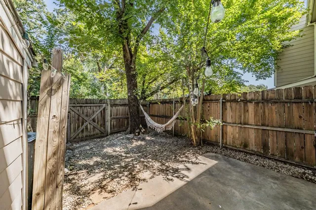 a view of a backyard with a tree