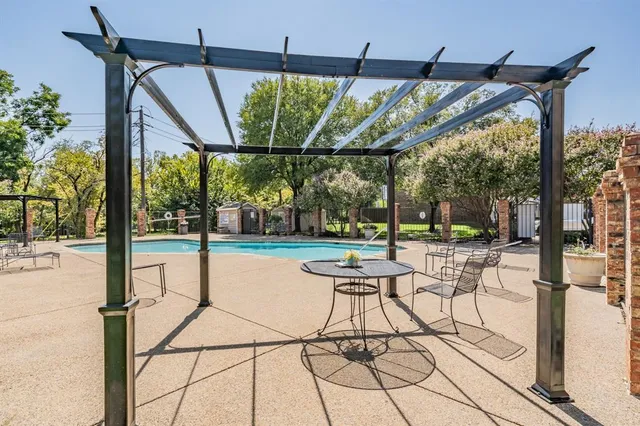 a patio with yard glass top table and chairs