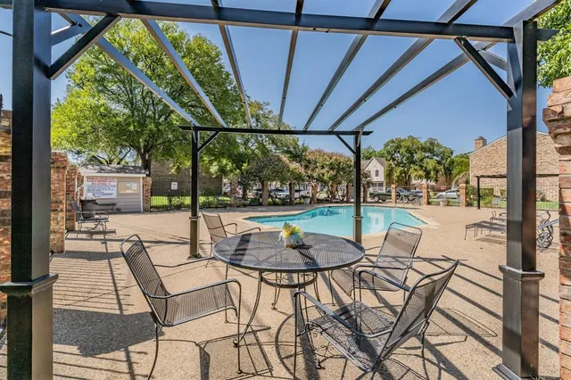 a view of a swimming pool with a patio