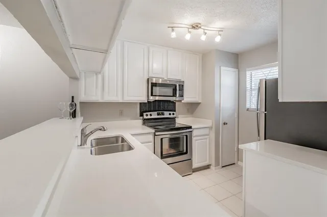 a kitchen with a stove and a refrigerator