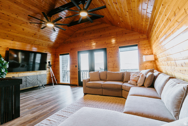 1413 Basel Drive Midway, UT 84049 - Photo 51 of 137 Living room featuring ceiling fan, wood finished floors, wooden walls, and wooden ceiling
