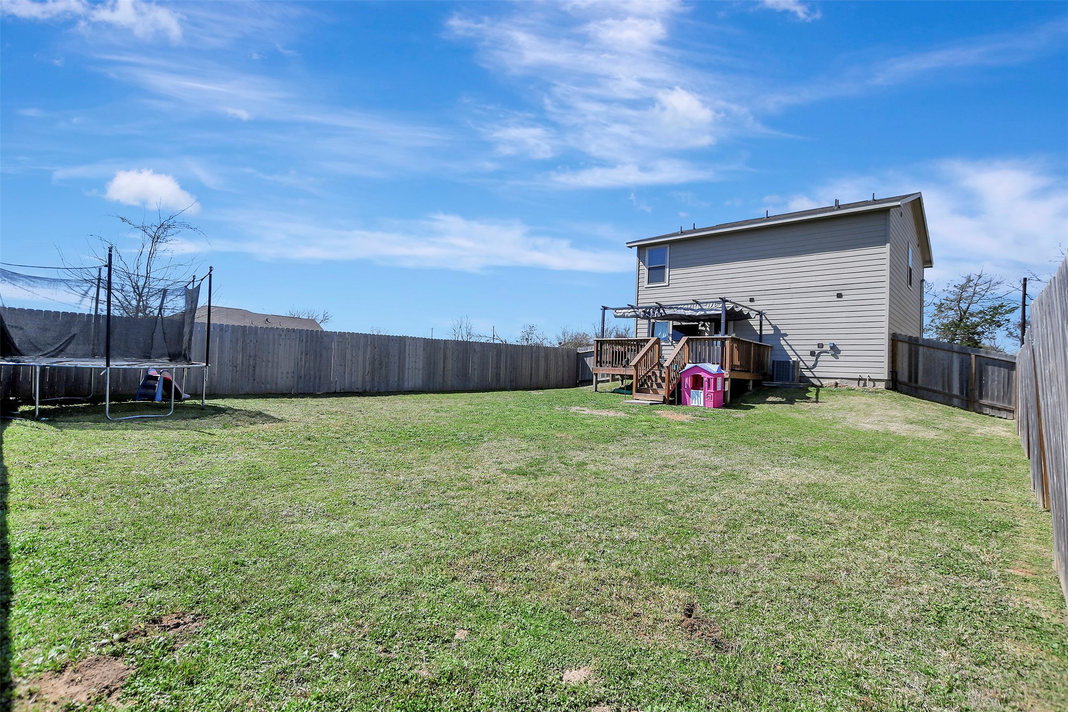 950 21st Street Hempstead, TX 77445 - Photo 31 of 35 Privacy-fenced backyard situated on the first of two lots, offering secure space for pets, play, or outdoor enjoyment.