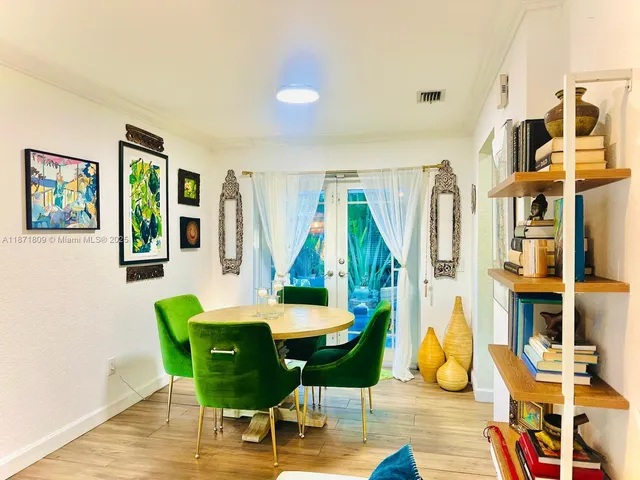 a view of a dining room with furniture and chandelier