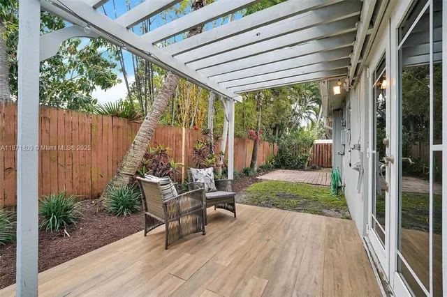 a view of a deck with chairs and wooden floor