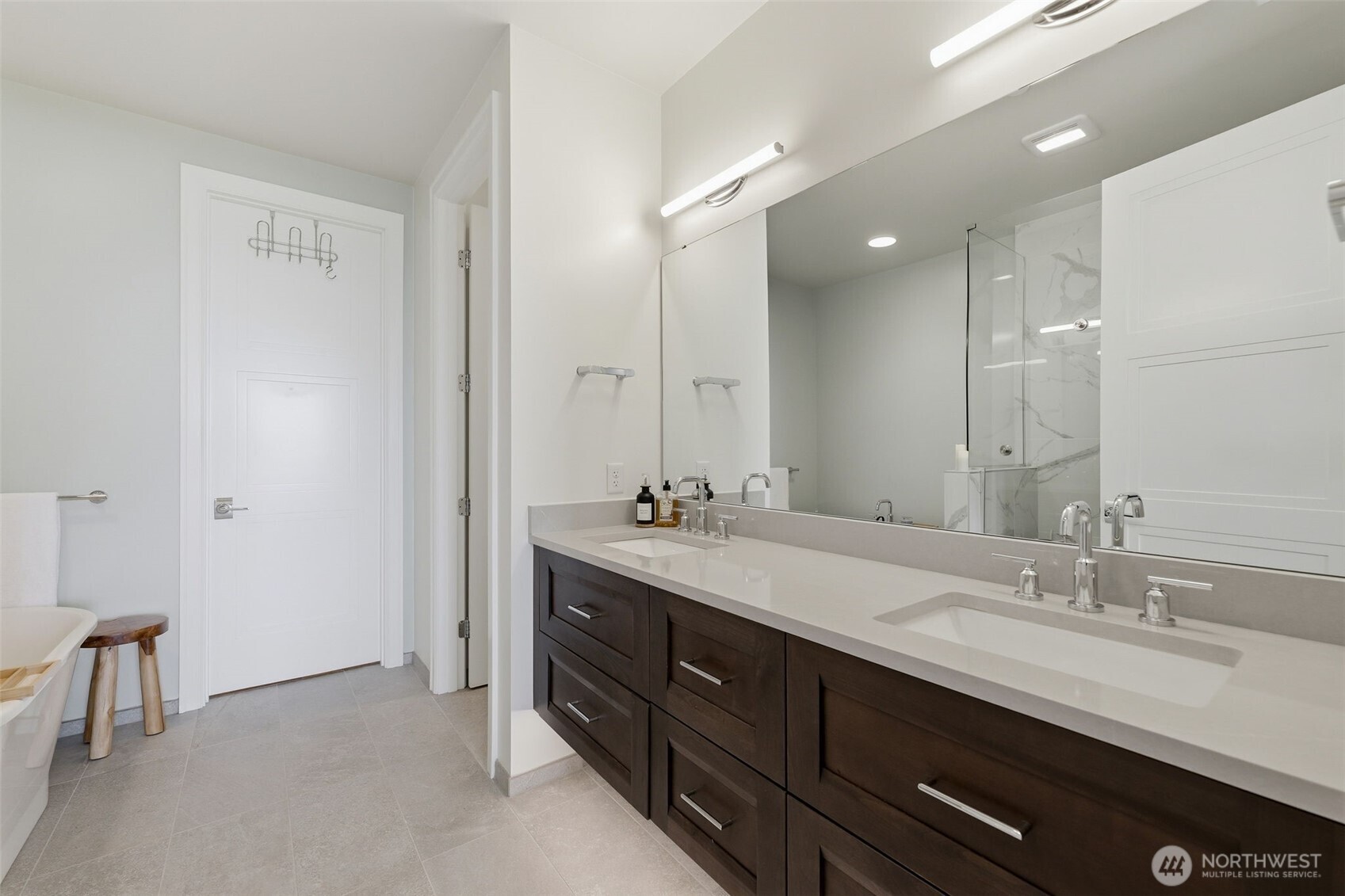 4907 Main Street, Unit 102 Tacoma, WA 98407 - Photo 14 of 34 a bathroom with a double vanity sink and a mirror
