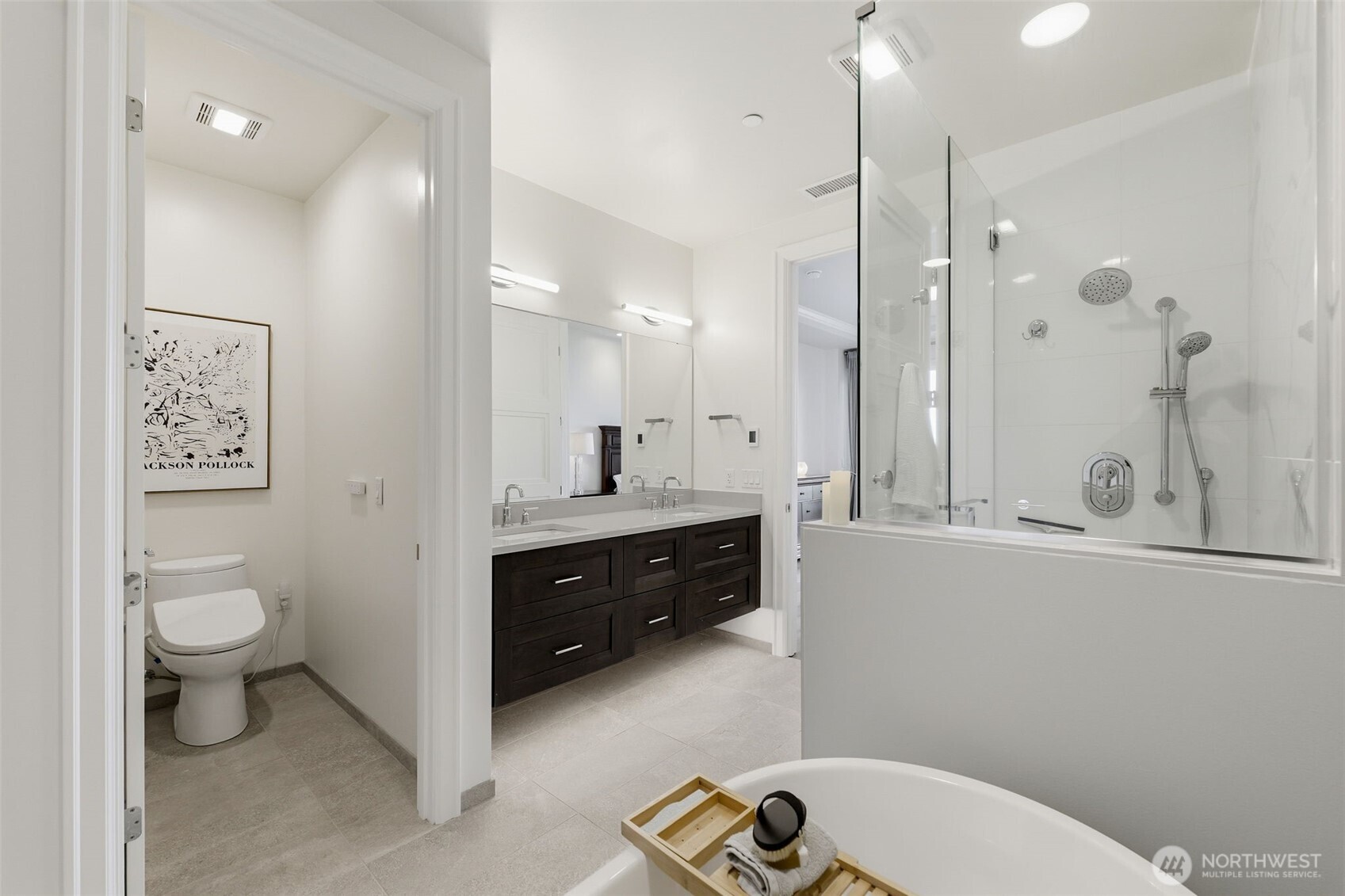 4907 Main Street, Unit 102 Tacoma, WA 98407 - Photo 16 of 34 a spacious bathroom with a double vanity sink toilet a mirror and shower