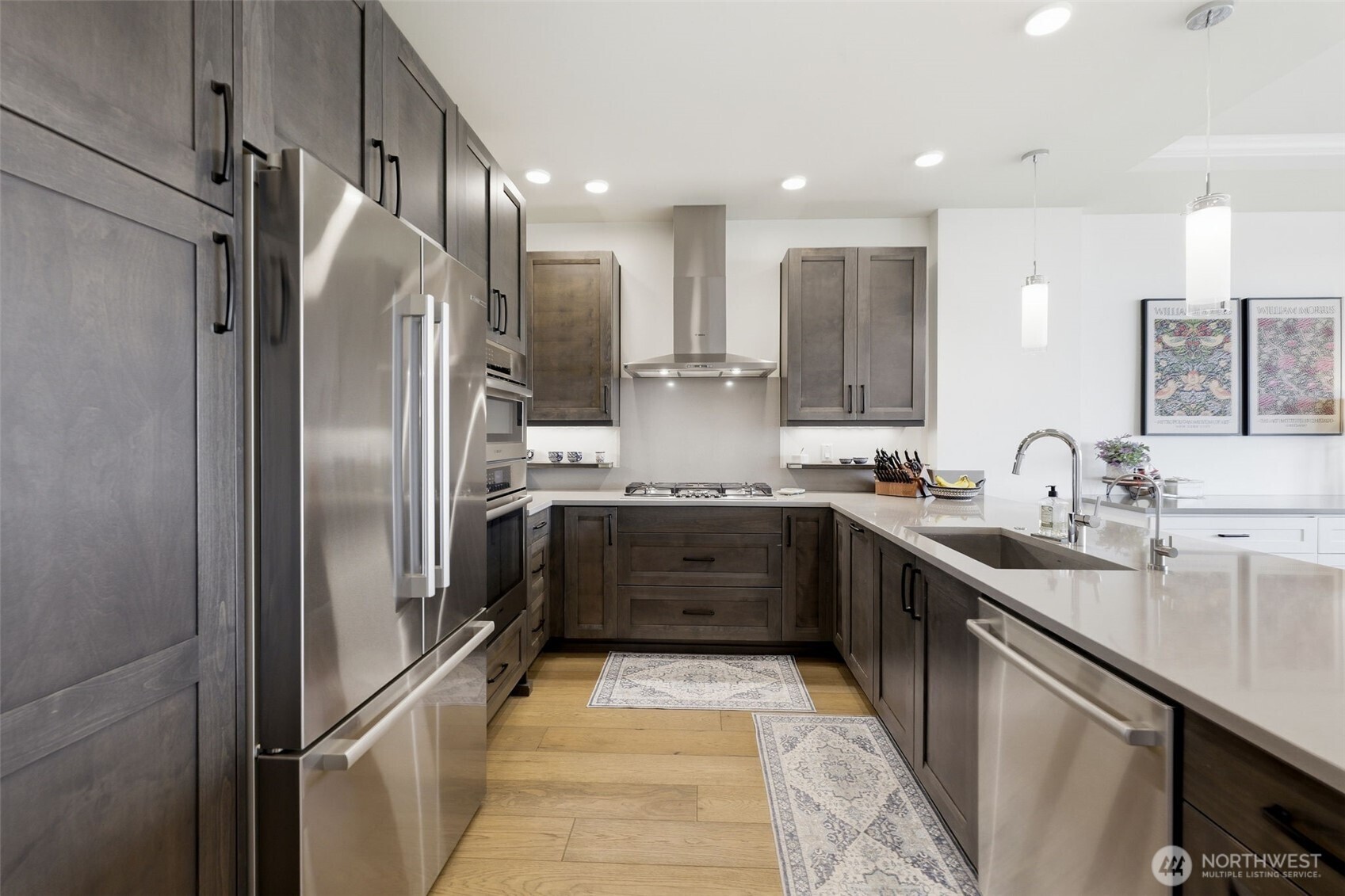 4907 Main Street, Unit 102 Tacoma, WA 98407 - Photo 5 of 34 a large kitchen with stainless steel appliances kitchen island granite countertop a refrigerator and a sink