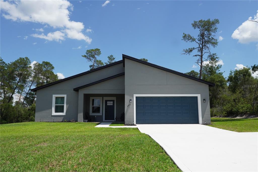 2914 Southwest 162nd Street Road Ocala, FL 34473 - Photo 45 of 47 a front view of a house with garden