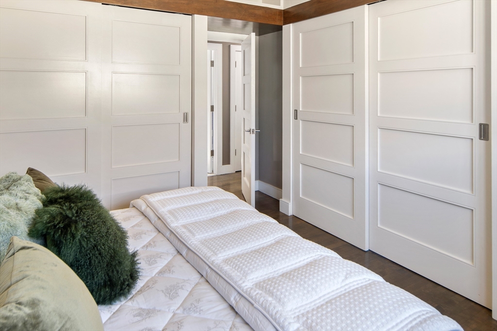 85 Sherman Street, Unit 10 Cambridge, MA 02140 - Photo 15 of 21 a spacious bedroom with a bed and a shower